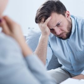 Man with depression talking with counselor.