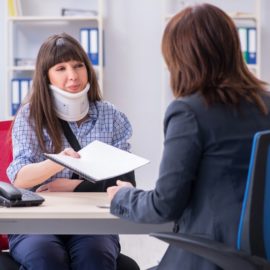 Injured employee visiting lawyer for advice on insurance.
