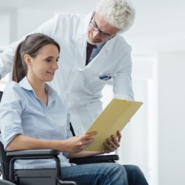 Woman in wheelchair holding her medical records.