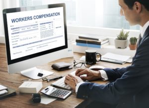 Man encoding workers compensation application form.